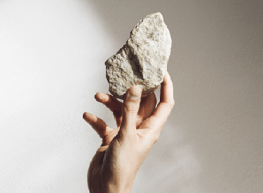 Hand holds Stone - Energy Efficiency Stonewool